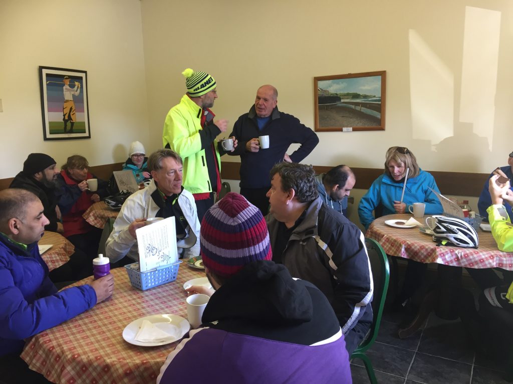 Will we or won't we ride today; Barney and Damian mull over options as other seated trekkers sup their brews.